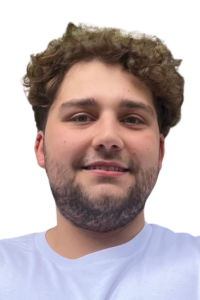 a man with curly hair and beard smiling